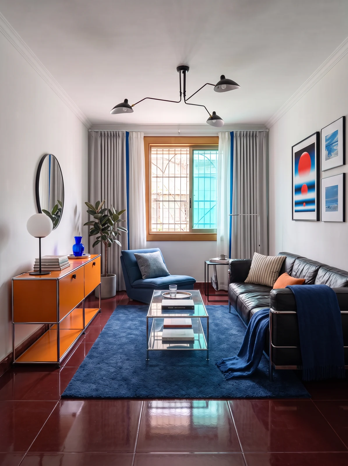 Proposed blue and chrome direction with a blue rug, black sofa, orange cabinet and burgundy floor.