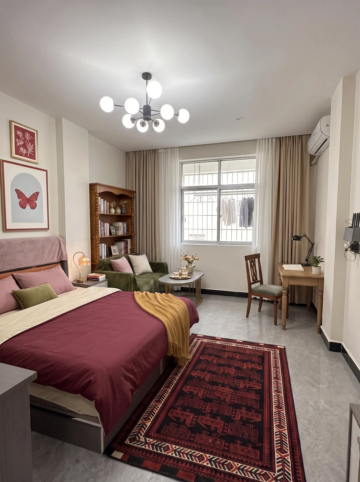 Proposed burgundy and books rental concept with burgundy bedding, olive sofa cover, wood reading furniture and patterned rug.